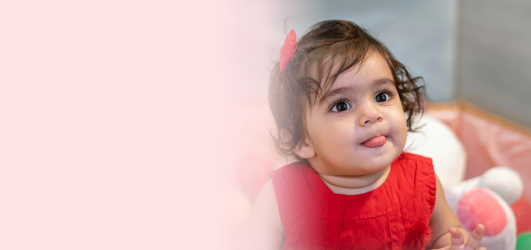 Smiling baby girl in a red dress